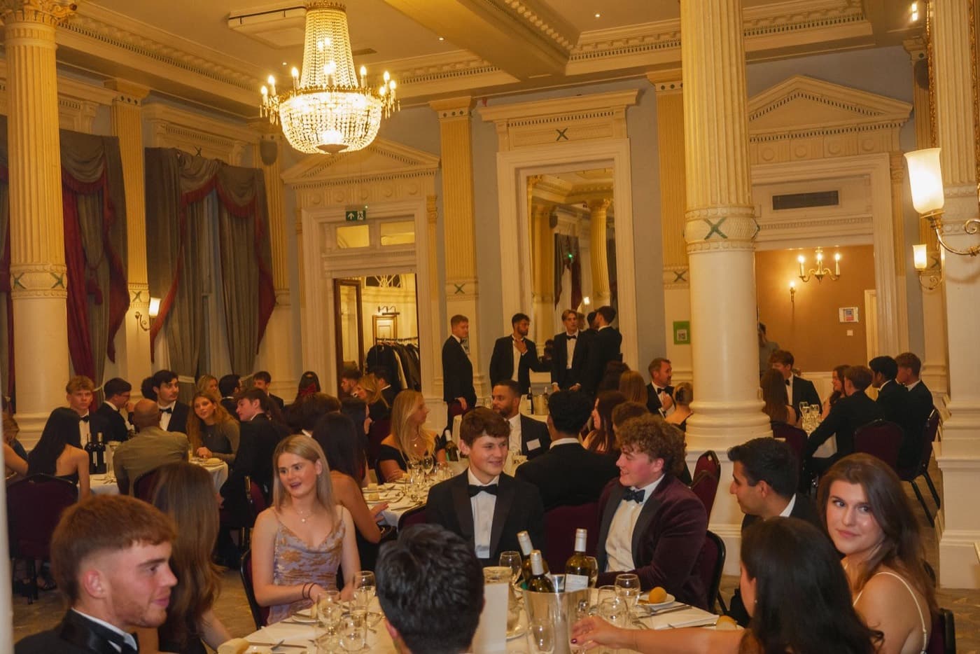 Guests in black tie seated at round tables in a chandeliered hall for the annual Careers Dinner
