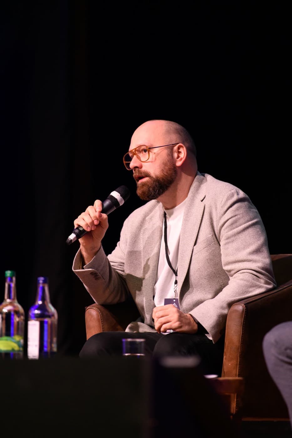 A guest speaker mid-answer on stage at a BFS panel event